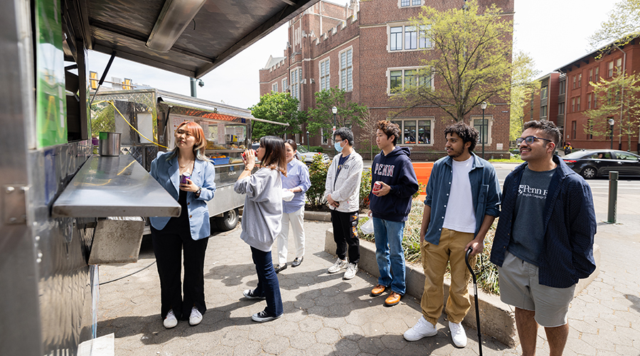 Students wait in line at a food truck
