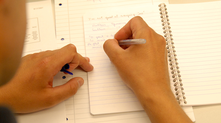 Photo of ELP student writing a paper in class