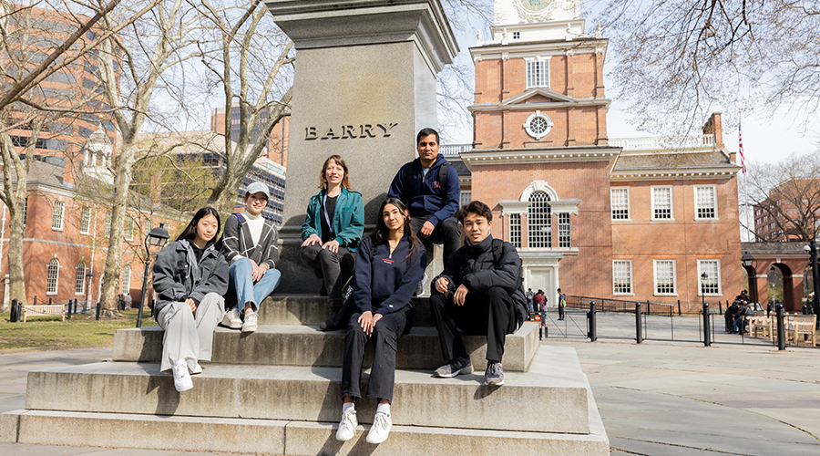 Students take a break from a tour of historic Independence Hall