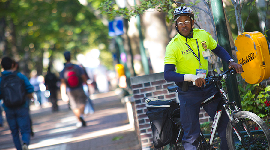 A campus safety office pulls over on his bike